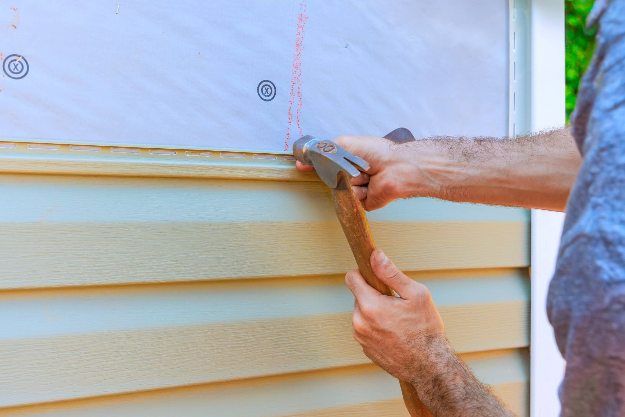 Person working on home siding installation