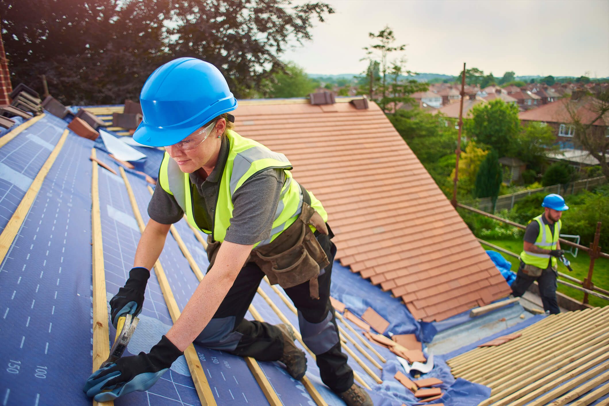 Roofers working on a house roof