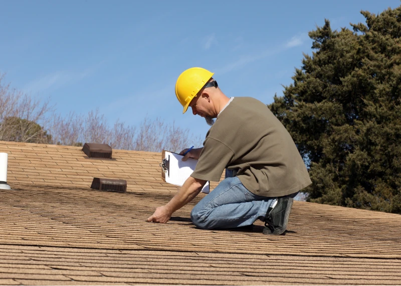 Man in hard hat checking roof condition