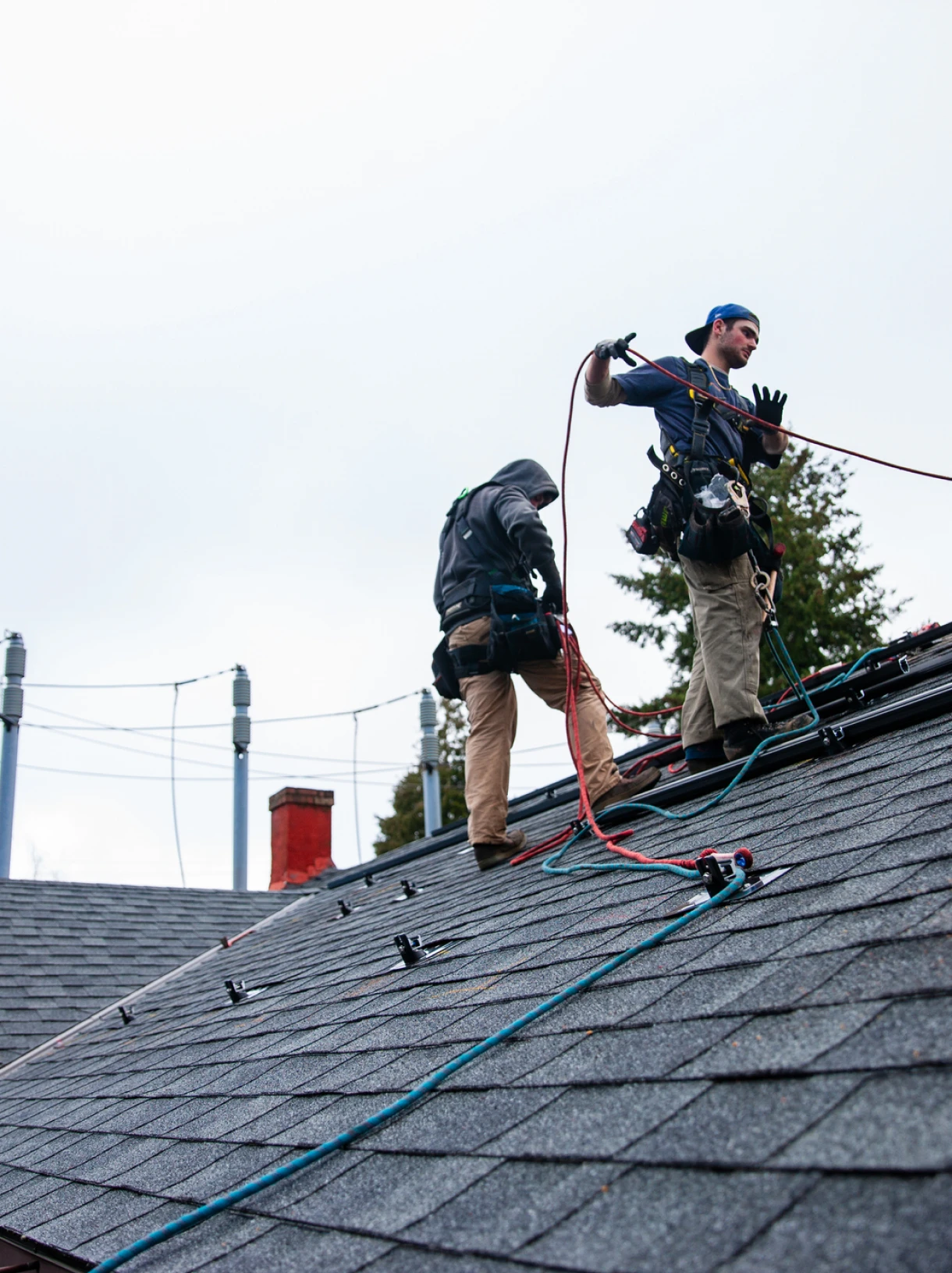 Construction workers installing shingles